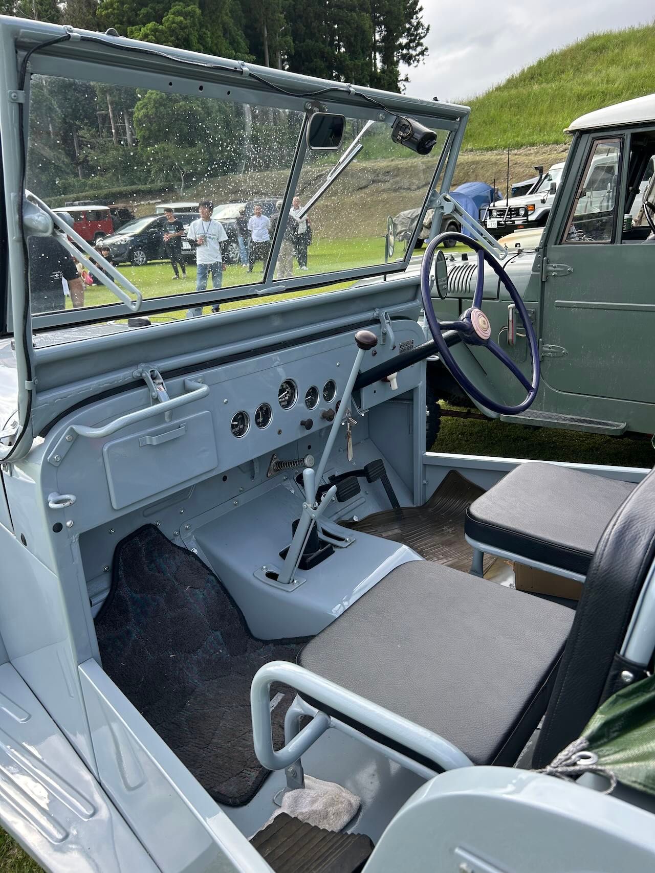 The interior of a 40 Series showing the classic blue steering wheel and minimalist dashboard.