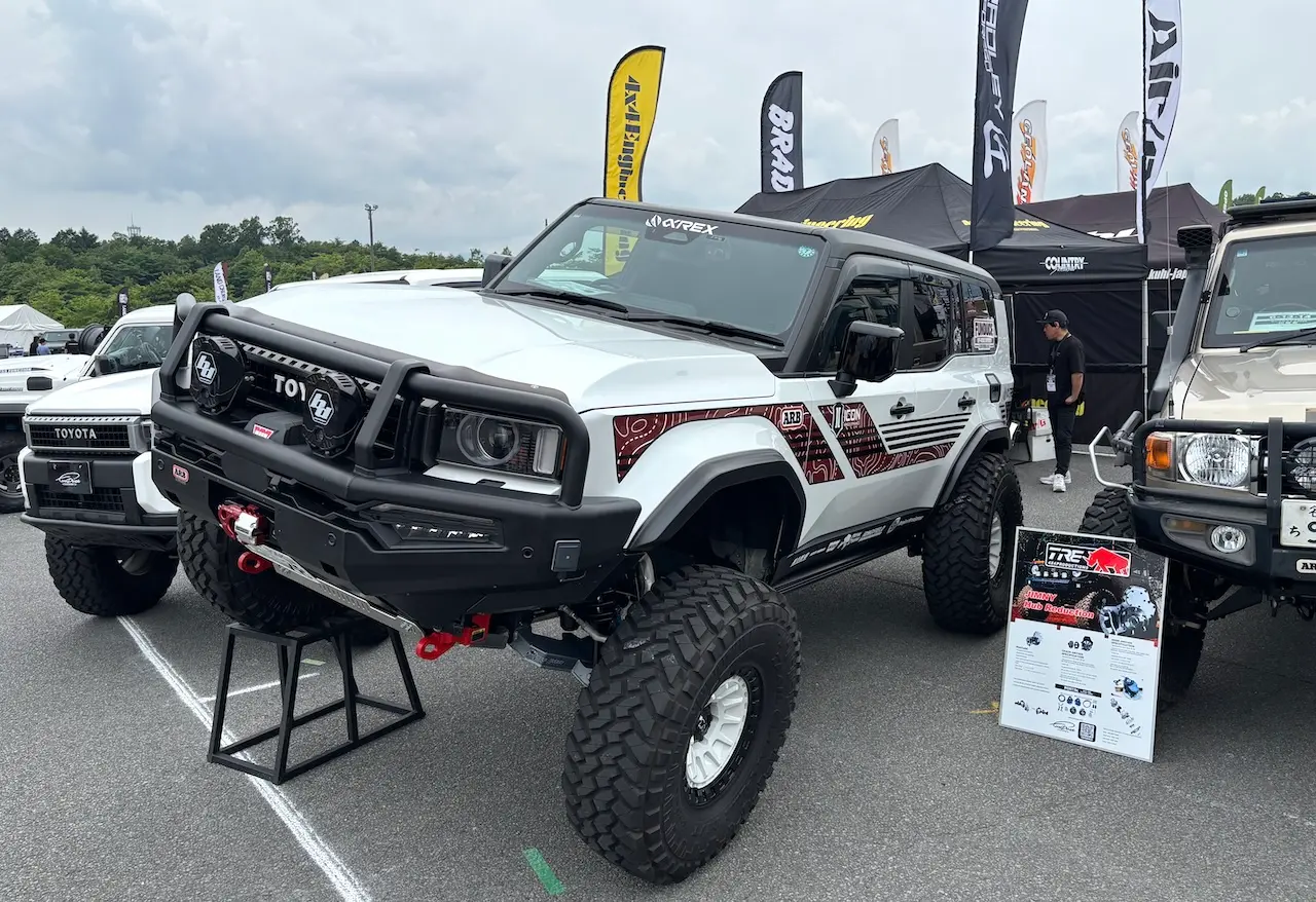 Professional shop booth with custom Land Cruiser parts on display at LAND CRUISER FES JAPAN 2026