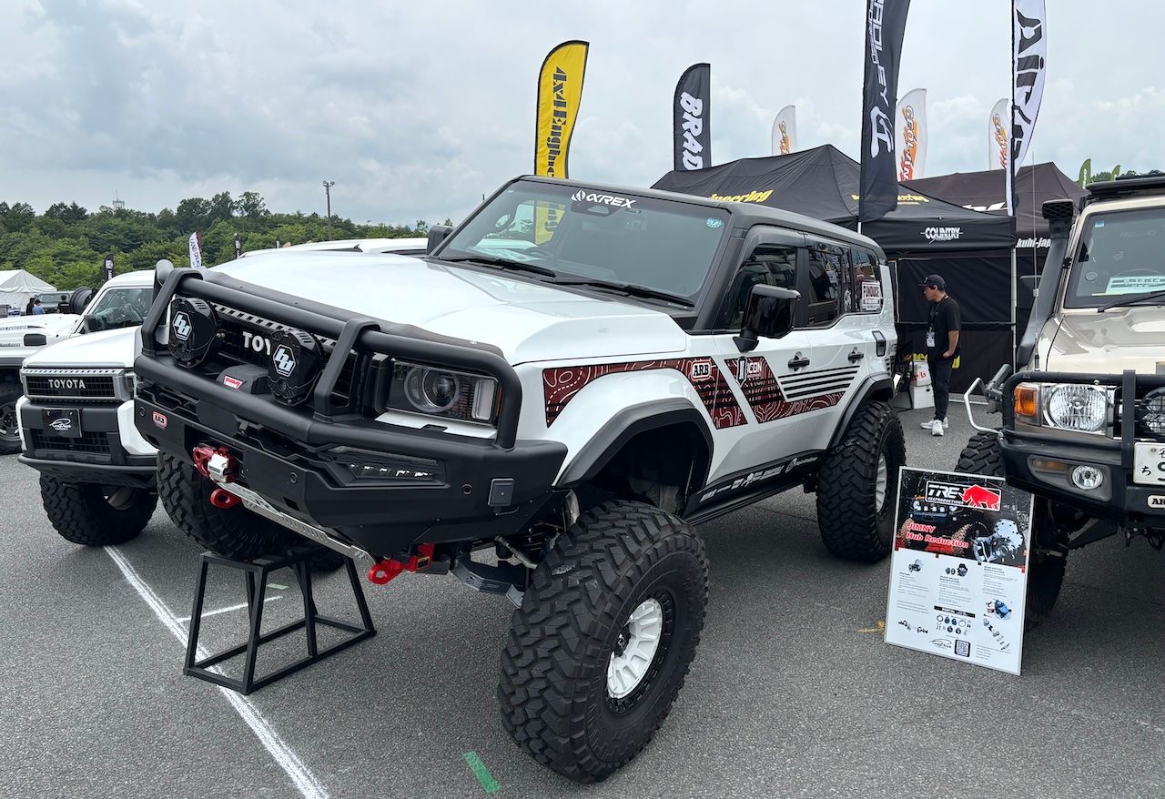 Professional shop booth with custom Land Cruiser parts on display at LAND CRUISER FES JAPAN 2026
